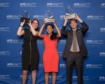 Jenny Lay-Flurrie, Haben Girma, and Jeff Wieland are each holding up a Helen Keller Achievement Award in front of a blue backdrop that says AFB American Foundation for the Blind. Photo by AFB.