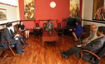 Dr. Tedros, Haben, and Haben's team seated in an office.