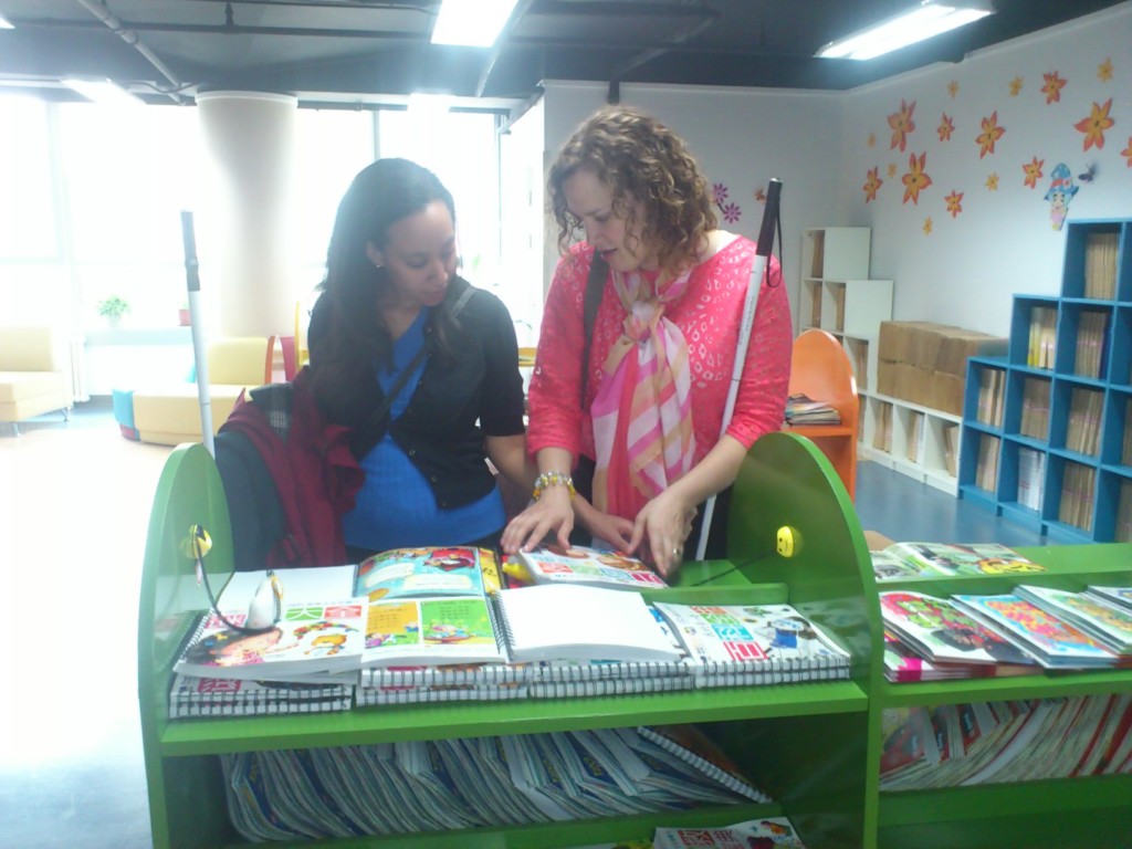 Haben and Tai read braille books at Library for the Blind