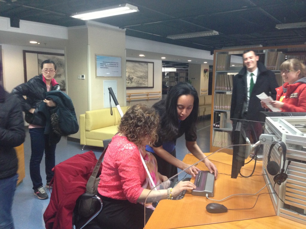 Haben and Tai use braille display at Library for the Blind