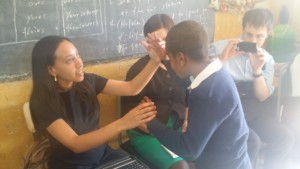 Haben tactile signing with student Kadus at the Victory School for the Deaf.