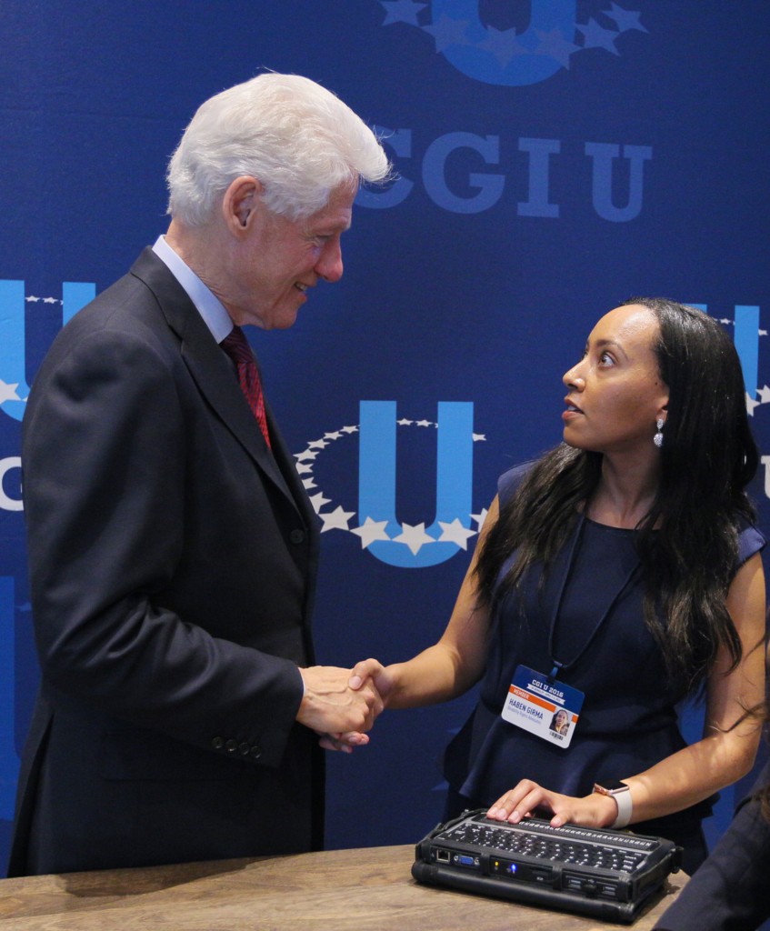 President Bill Clinton shakes hands with Haben Girma