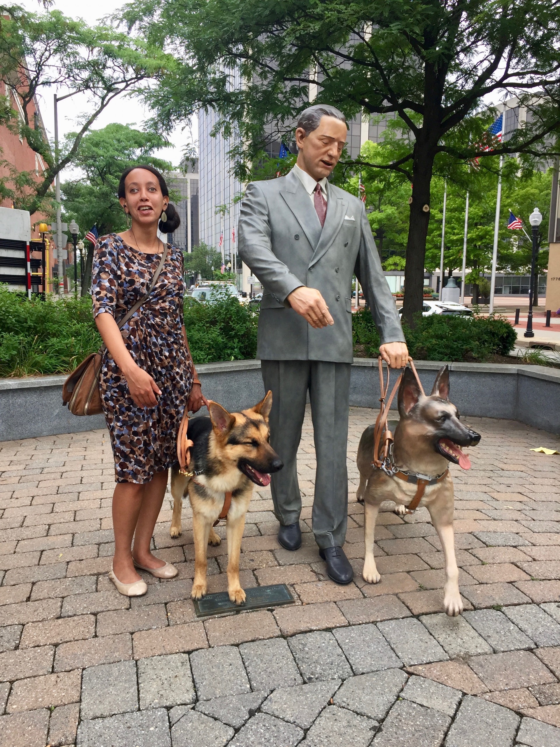 Haben and Mylo next to guide dog statue at The Seeing Eye