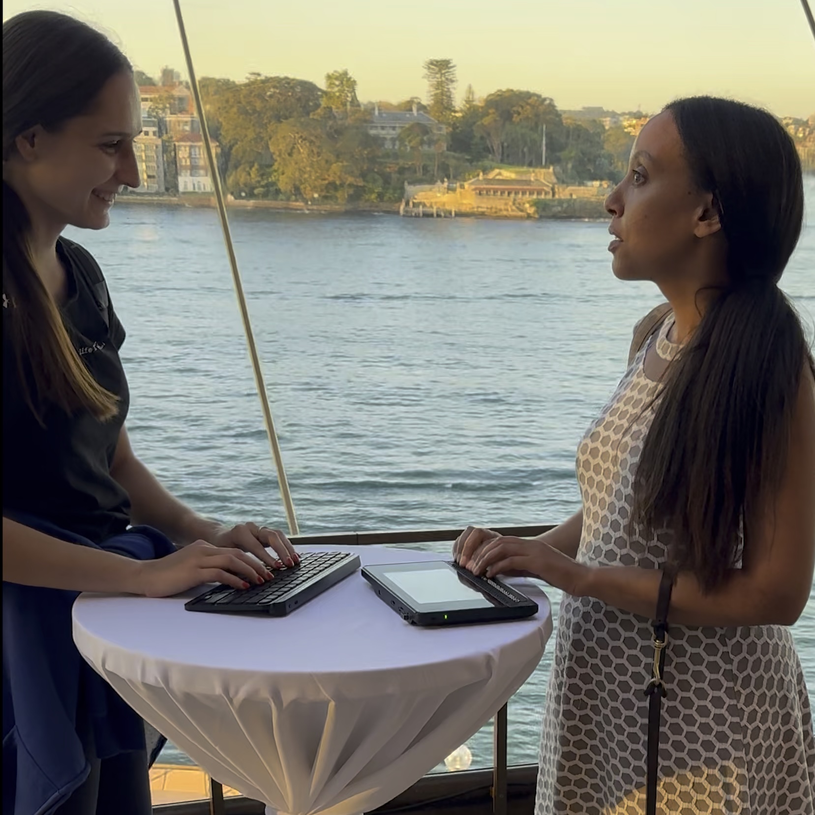 Haben and Nessa communicating using a keyboard and braille display at the Sydney Opera House